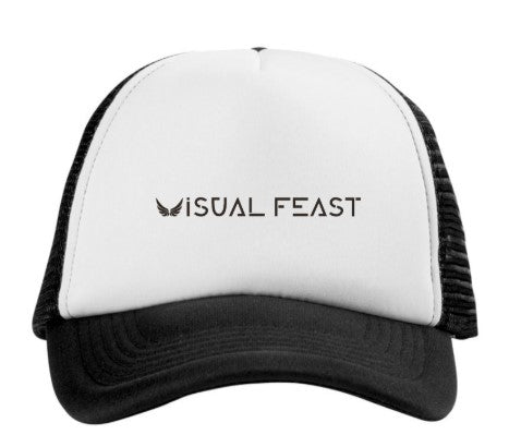 A black and white trucker hat with a white front panel and black mesh back, featuring the text 'VISUAL FEAST' printed in black on the front.